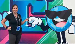 Becky and Esri mascot, “Globie”, fist bump to an informative, successful conference.