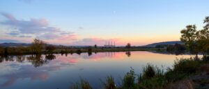Panoramic View Of A Lake At Sunset With A Coal Power Station